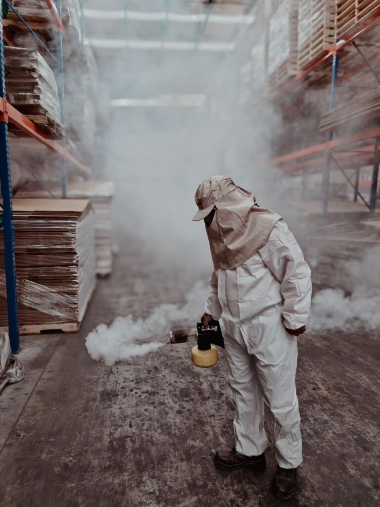 Pest inspection and treatment by a technician in protective gear